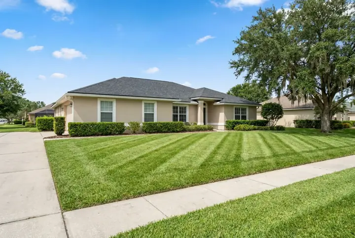 A freshly mowed front lawn with neat stripes